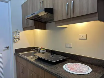 a kitchen with a sink and a plate on the counter at Bless View at 16th in Manila