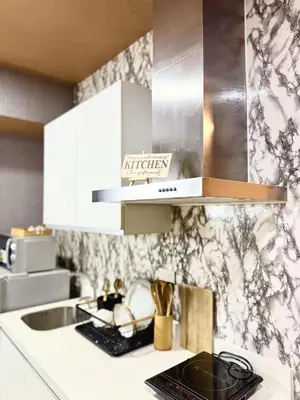 a kitchen with a sink and a counter top at Cozy Condo near Manila Airport in Manila