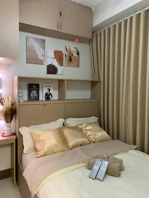 a bedroom with a bed with two books on it at PEACETIME CONDO FIELD RESIDENCES BLDG 6 u1006B in Manila