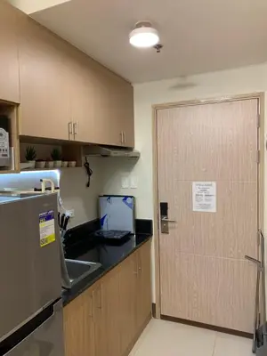 a kitchen with a door and a sink and a counter at PEACETIME CONDO FIELD RESIDENCES BLDG 6 u1006B in Manila