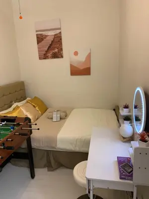 a small room with a bed and a table at PEACETIME CONDO FIELD RESIDENCES BLDG 6 u1006B in Manila