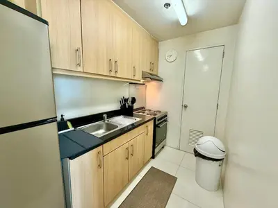 a small kitchen with a sink and a stove at Spacious Tropics with Golf View in BGC in Manila