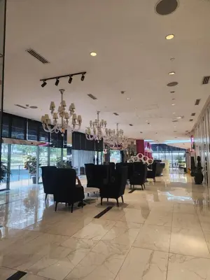 a lobby with chairs and tables in a building at Azure Staycation Philippines by AMRS Near Manila International Airport in Manila