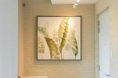 a framed picture of leaves on a wall at Tropical Sunset w the best view in BGC plus Netlfix in Manila