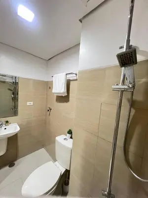 a bathroom with a toilet and a sink and a shower at Unistay SHORE Residence w Balcon Amazing Manila Bay View in Manila