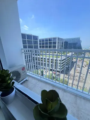 a balcony with a view of a beach and a building at Unistay SHORE Residence w Balcon Amazing Manila Bay View in Manila