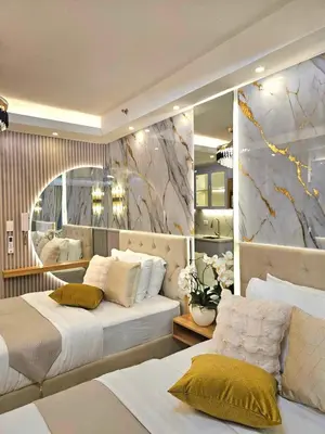 a bedroom with two beds and a large mirror at Serenity Suite in Manila