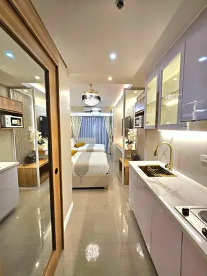a kitchen and a bedroom with a bed in a room at Serenity Suite in Manila