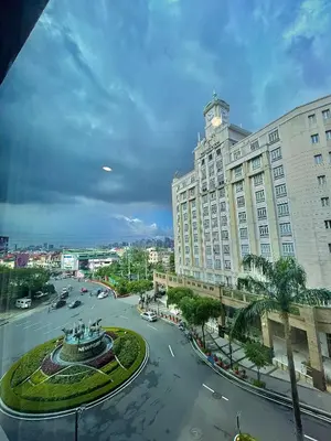 a large building with a clock tower on top of it at NAIA Terminal 3 Condo Newport with WIFI Netflix Pool in Manila