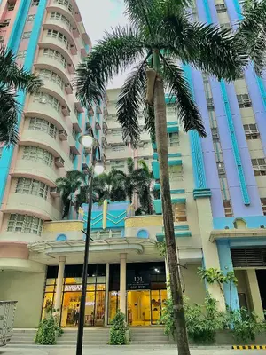 a large building with palm trees in front of it at NAIA Terminal 3 Condo Newport with WIFI Netflix Pool in Manila