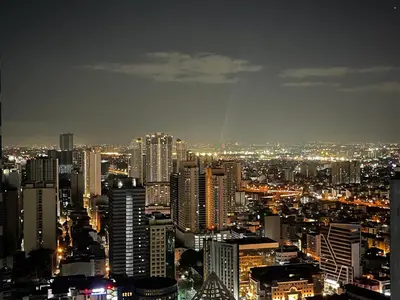 a view of a city at night with lights at 1 BR Condo w Balcony in Air Residence Makati in Manila