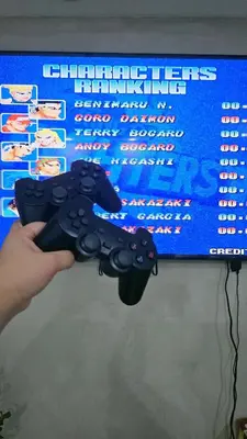 a person holding a video game controller in front of a tv at Cozy Apartment Azure Urban Resort Residences in Manila