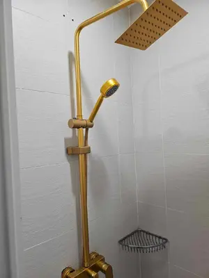a shower with a gold shower head in a bathroom at Cozy Apartment Azure Urban Resort Residences in Manila