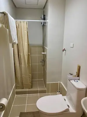 a bathroom with a toilet and a shower at Condo unit near SM City Sta Rosa Unit 2 in Ibaba