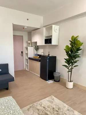 a room with a kitchen and a living room at Condo unit near SM City Sta Rosa Unit 2 in Ibaba