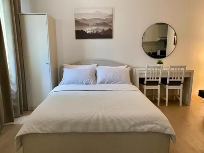 a bedroom with a bed with a desk and a mirror at Condo unit near SM City Sta Rosa Unit 2 in Ibaba
