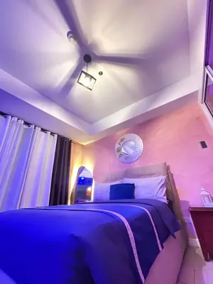 a bedroom with a blue bed with a ceiling at Azure Urban Resort Residences - Staycationary Miami 1710 in Manila