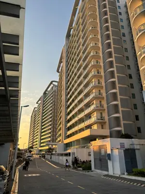 a group of tall buildings next to a street at Azure Urban Resort Residences - Staycationary Miami 1710 in Manila