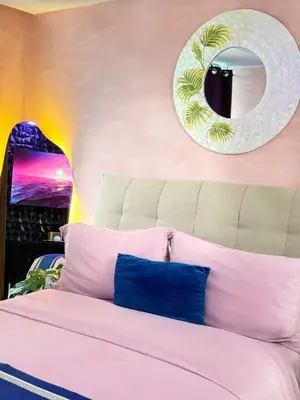 a bedroom with a large bed with a mirror on the wall at Azure Urban Resort Residences - Staycationary Miami 1710 in Manila
