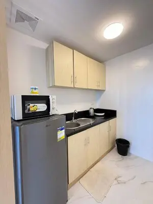 a kitchen with a refrigerator and a sink at Malate Bayview Mansion Korean Town 1Bedroom in Manila
