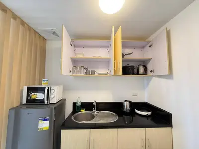 a small kitchen with a sink and a microwave at Malate Bayview Mansion Korean Town 1Bedroom in Manila