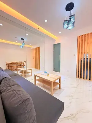 a living room with a couch and a table at Malate Bayview Mansion Korean Town 1Bedroom in Manila