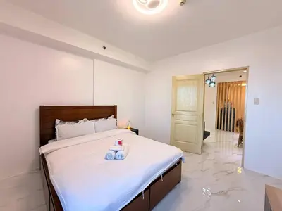 a bedroom with a bed with a teddy bear on it at Malate Bayview Mansion Korean Town 1Bedroom in Manila