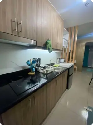 a kitchen with a sink and a counter top at Modern Comfort at Shore 2 MOA in Manila