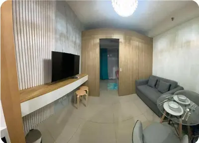 a living room with a couch and a television at Modern Comfort at Shore 2 MOA in Manila