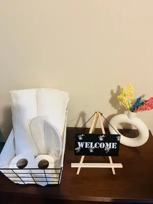 a basket of towels and a sign on a table at BGC Simple Elegant 300Mbps Wifi,Pool,Netflix in Manila