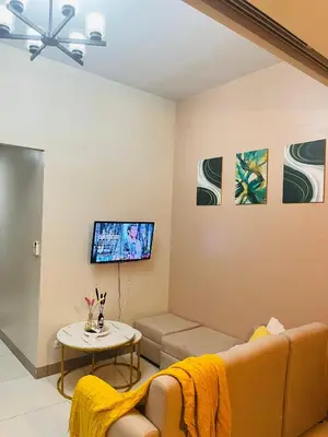 a living room with a couch and a table at BGC Simple Elegant 300Mbps Wifi,Pool,Netflix in Manila
