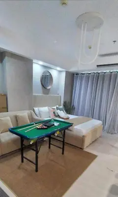 a living room with a couch and a ping pong table at Cozy Apartment Azure Urban Resort Residences in Manila