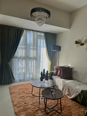 a living room with a couch and a table at King Size 3-Bedroom in Uptown Parksuites BGC in Manila