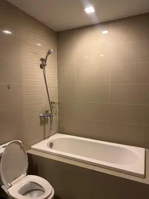 a bathroom with a bath tub and a toilet and a bath tub at King Size 3-Bedroom in Uptown Parksuites BGC in Manila