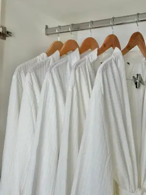 a group of white curtains hanging on a rack at King Size 3-Bedroom in Uptown Parksuites BGC in Manila