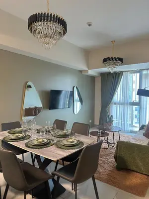 a dining room with a table and chairs at King Size 3-Bedroom in Uptown Parksuites BGC in Manila