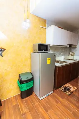 a kitchen with a refrigerator with a microwave on it at City of Dreams Luxury Makati 5637 Swim Gym Netflix Superfast Surfing in Manila