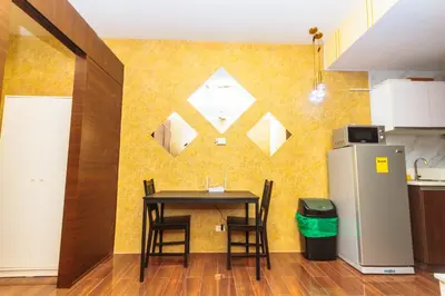 a dining room with a table and a refrigerator at City of Dreams Luxury Makati 5637 Swim Gym Netflix Superfast Surfing in Manila