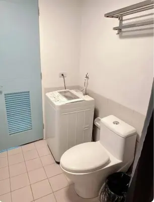 a bathroom with a white toilet and a sink at Torre de manila taft 23 in Manila