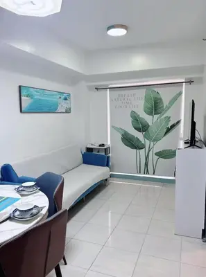a living room with a couch and a table at Torre de manila taft 23 in Manila