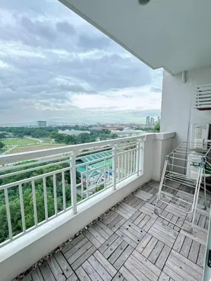 a balcony with chairs and a view of the city at Torre de manila taft 23 in Manila