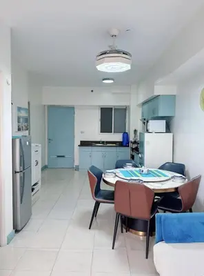 a kitchen and dining room with a table and chairs at Torre de manila taft 23 in Manila