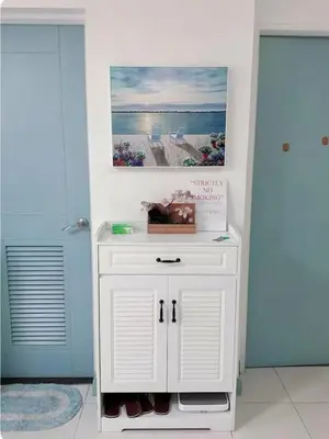 a small white cabinet in a room with two doors at Torre de manila taft 23 in Manila