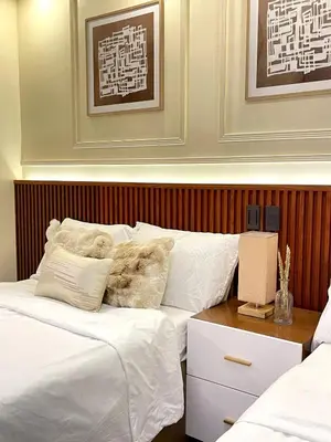 a bedroom with two beds with white sheets at Belfort Suite by Crib2GO in Manila