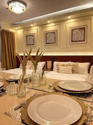 a dining room with a table with plates on it at Belfort Suite by Crib2GO in Manila