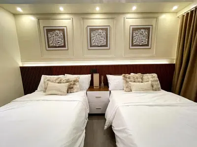 a bedroom with two beds with white sheets at Belfort Suite by Crib2GO in Manila