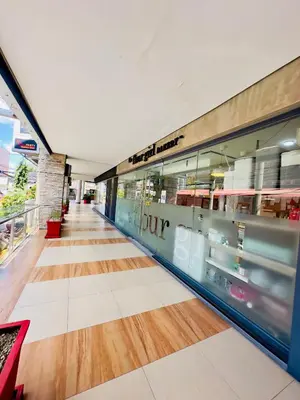 a hallway of a building with a store at Cozy Laura at ACE Plaza in Manila