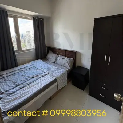 a small bedroom with a bed and a window at Coast Residences Staycation in Manila