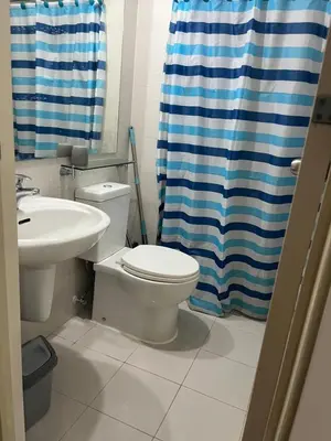 a bathroom with a toilet and a sink at Azure Condo Maui by arlene in Manila