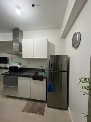a kitchen with a stainless steel refrigerator at Azure Condo Maui by arlene in Manila